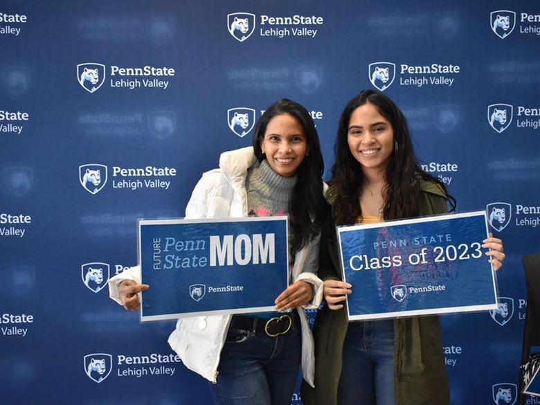 two women smiling in front of penn state lehigh valley logo backdrop 